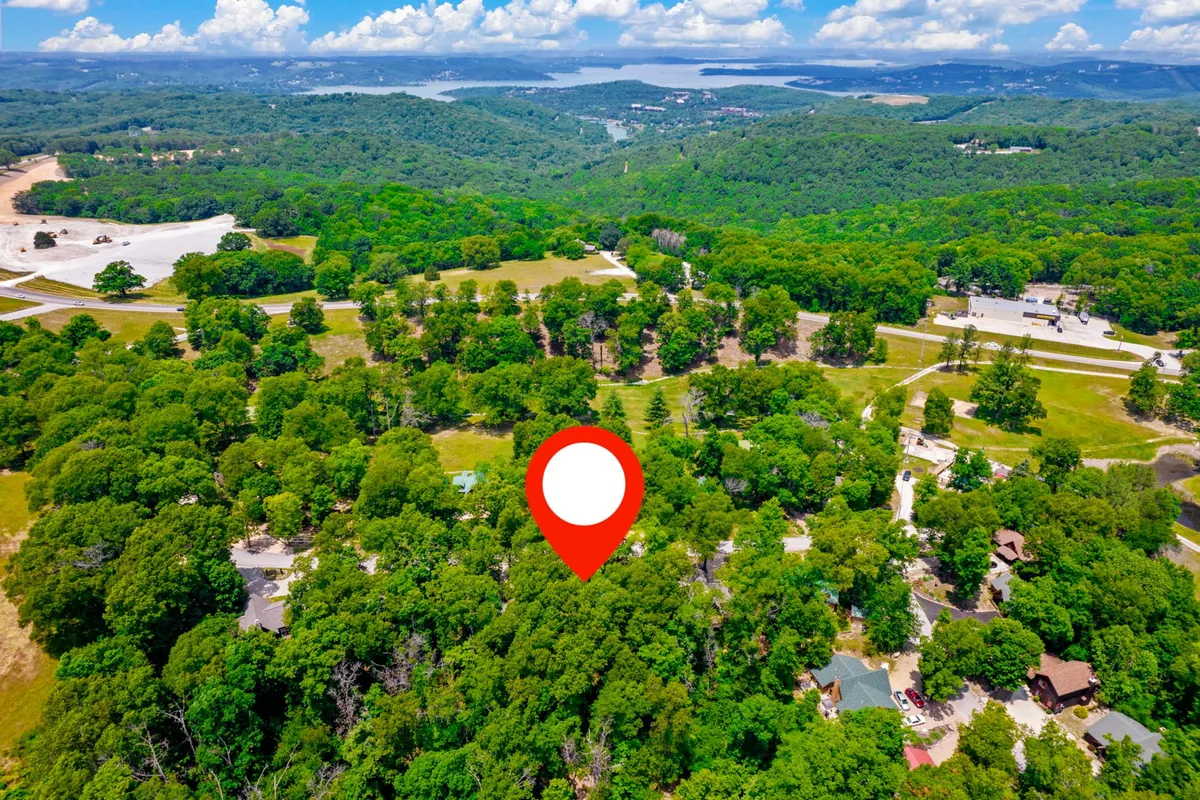 A tranquil view featuring lush greenery, a distant lake, and scattered homes. The peaceful landscape hints at opportunities for hiking, picnicking, and nature watching, with the chance for stunning sunset views and wildlife sightings.